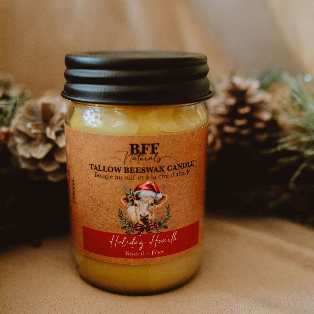 Tallow beeswax candle in a jar with a decorative label on a neutral background