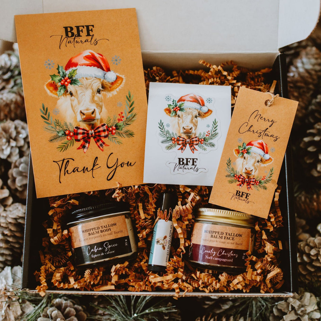 Gift box with candles, cards, and decorative items on a festive background